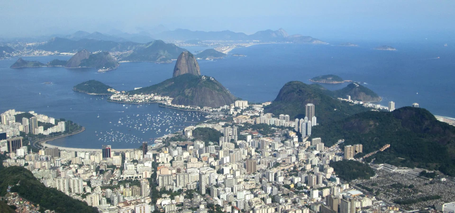 Aerial view over Botafogo, a bay full of boats and Sugarloaf Mountain rising from Guanabara Bay