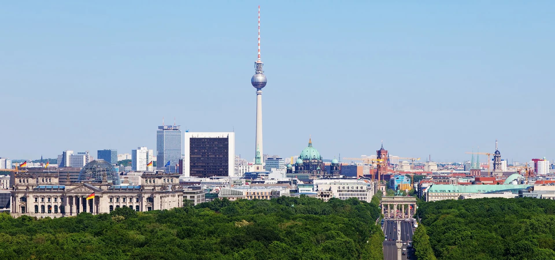 Berlin skyline above the green Tiergarten, with the Reichstag dome, the TV Tower and Berlin Cathedral