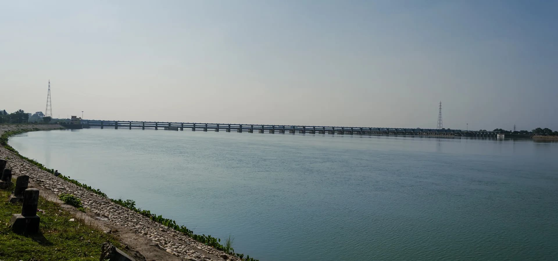 The wide Gandak River at Valmiki Nagar with the long barrage crossing it under a hazy sky