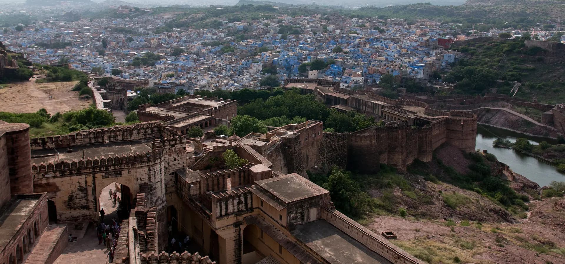 View from Mehrangarh Fort over its gates and ramparts to the blue houses of Jodhpur and desert hills