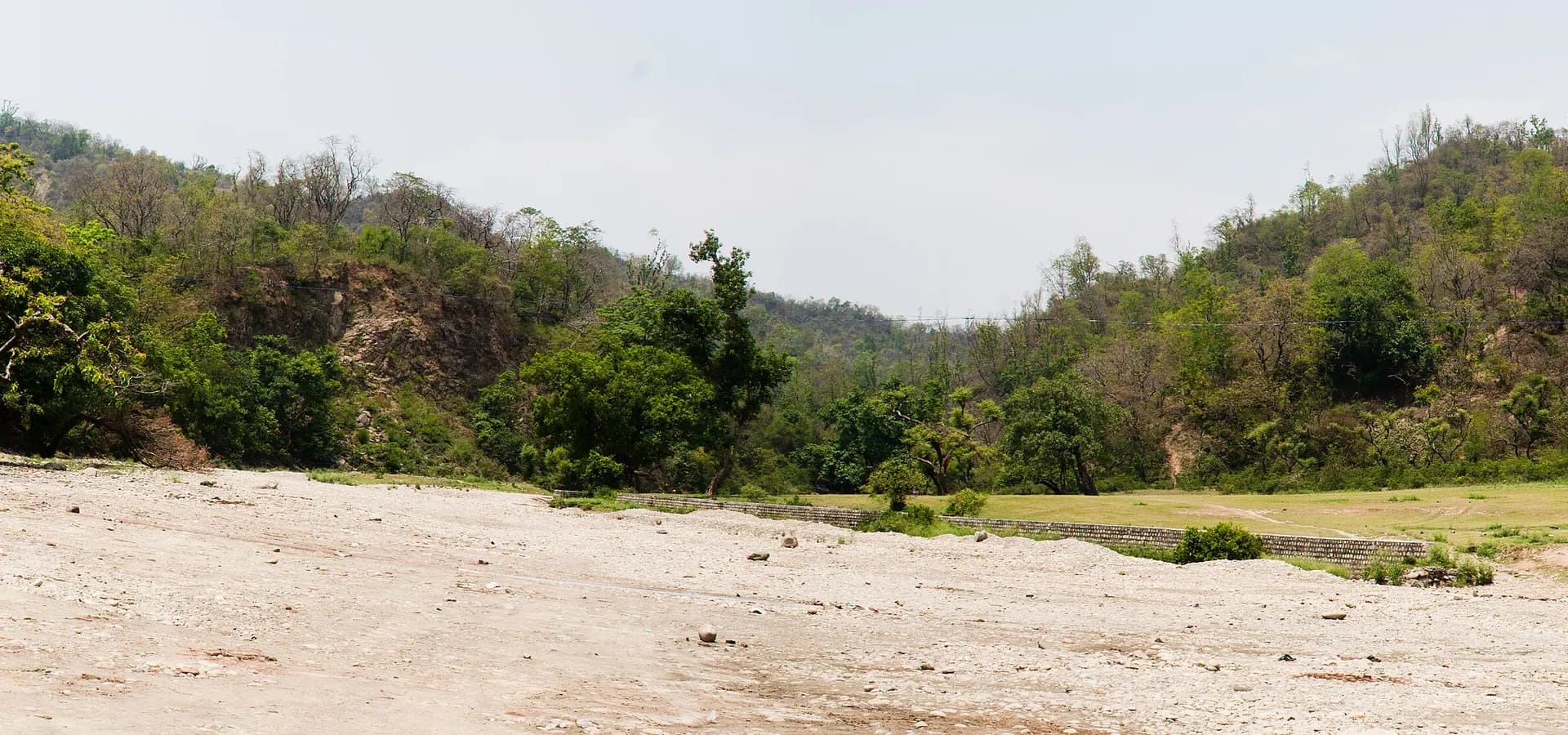Wide stony riverbed below green forested Shivalik hills near Shakumbhari Devi, north of Saharanpur