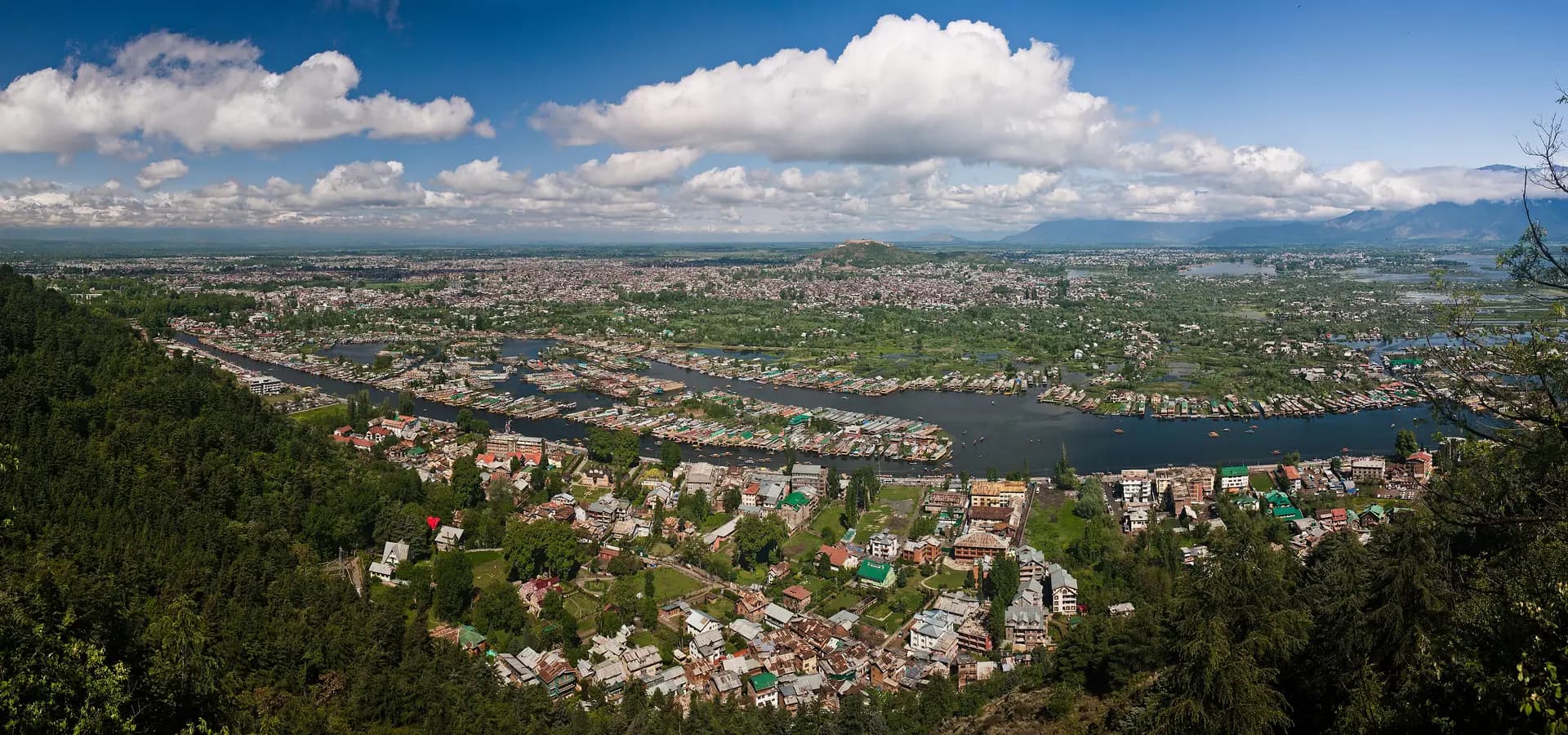 Panoramic view over Srinagar, with houseboat-lined channels of Dal Lake, the city and distant mountains